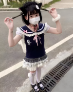 Model wearing the Midnight Panda Sailor Tee, a black kawaii t-shirt with panda and sailor collar details.