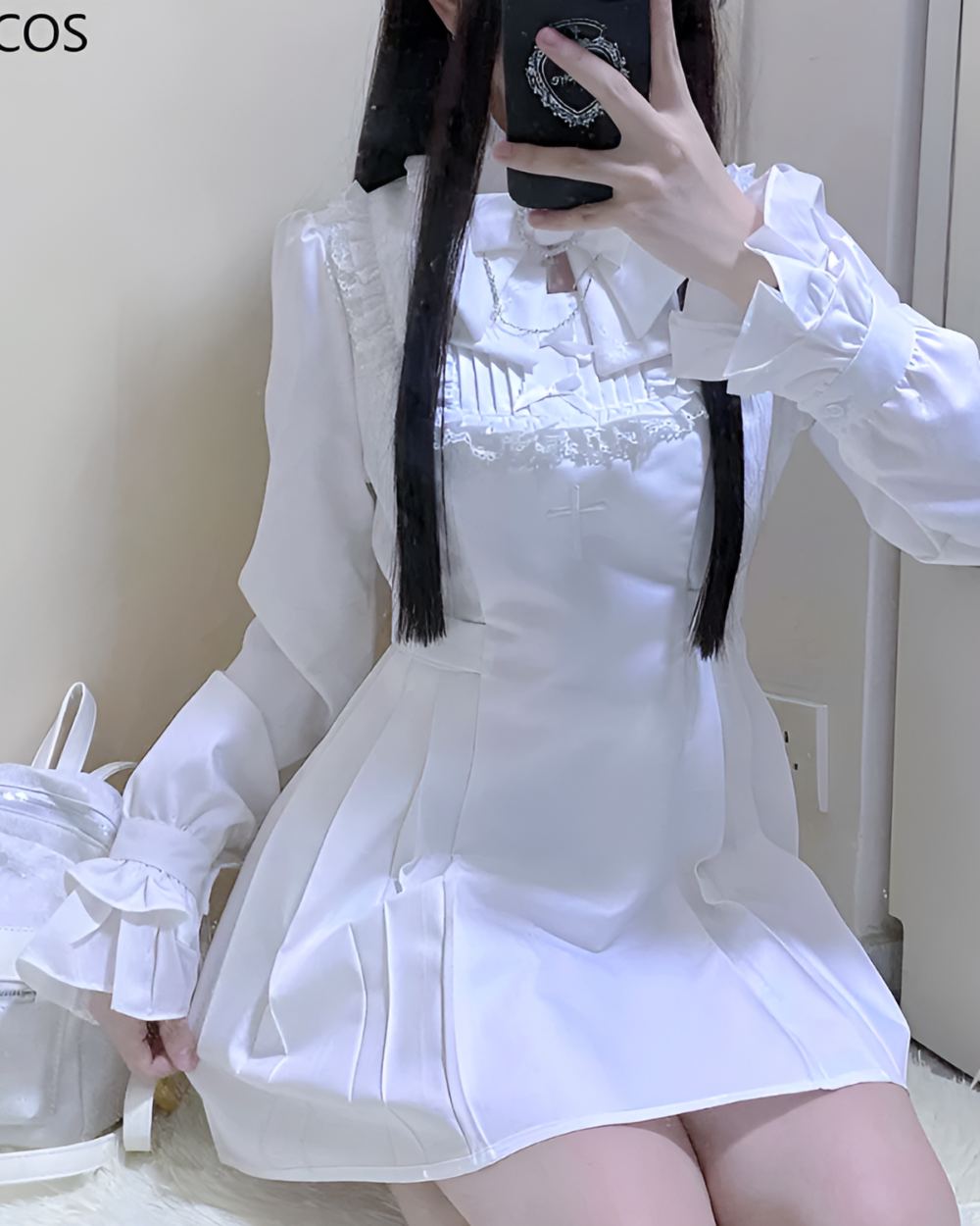 Woman wearing white Midnight Ruffled Coord with a Jirai Kei aesthetic. Ruffled details and long sleeves.