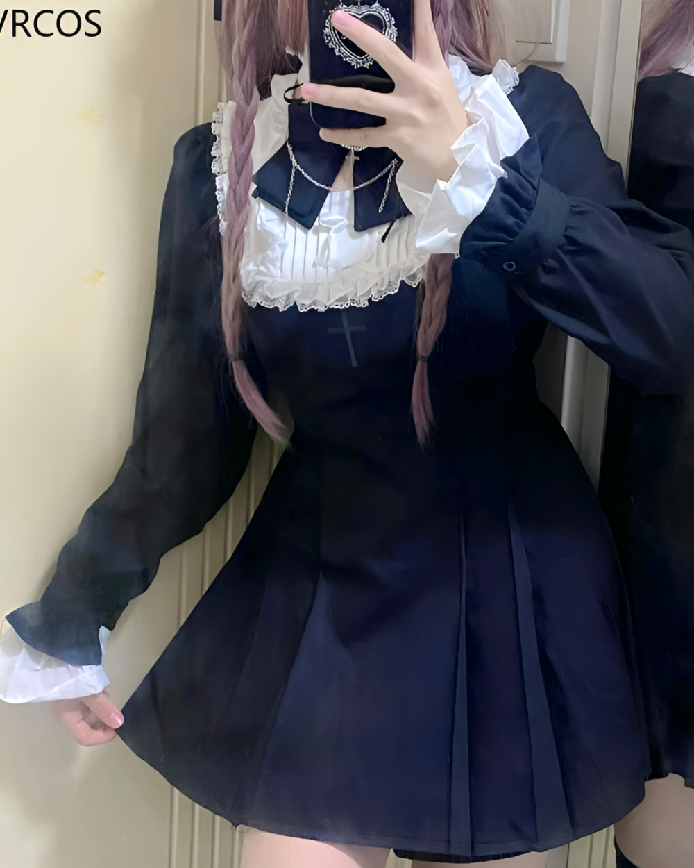 Woman wearing a black Midnight Ruffled Coord with white lace details, embodying the Jirai Kei aesthetic. Features sheer sleeves and a pleated skirt.