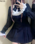 Woman wearing a black Midnight Ruffled Coord with white lace details, embodying the Jirai Kei aesthetic. Features sheer sleeves and a pleated skirt.