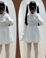 Woman modeling the Midnight Ruffled Coord, showcasing a Jirai Kei aesthetic with a white ruffled dress and matching accessories.