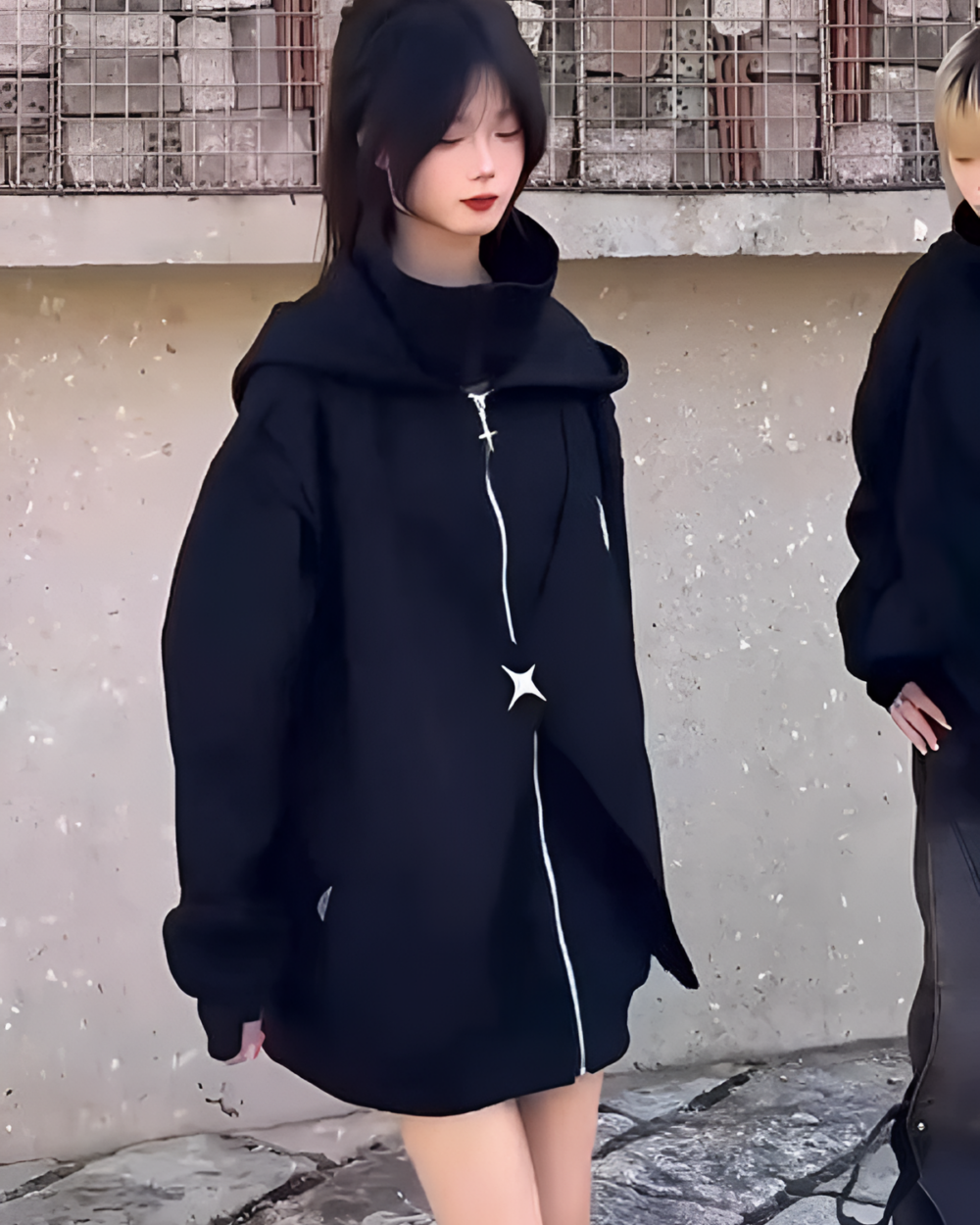 Woman wearing a black Moonlight Zipper Hoodie with a front zipper. Casual oversized fit, street style fashion.