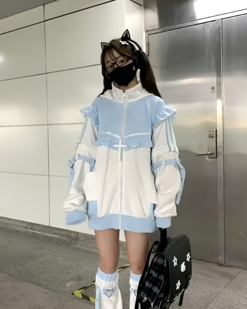 Model wearing a Neko Frill Zip Hoodie in a pastel goth aesthetic. The hoodie features frills and a zip-up design.