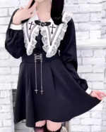 Black Jirai Kei blouse with lace and cross details. Long sleeves and flared skirt. Features a collar and ribbon ties.