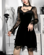 Model wearing the Nocturne Moon-Charm Skater Dress, a black velvet skater dress with lace details and sheer sleeves.