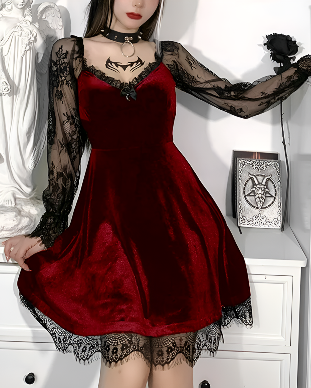 Woman wearing a red velvet Nocturne Moon-Charm Skater Dress with lace details and sheer sleeves.
