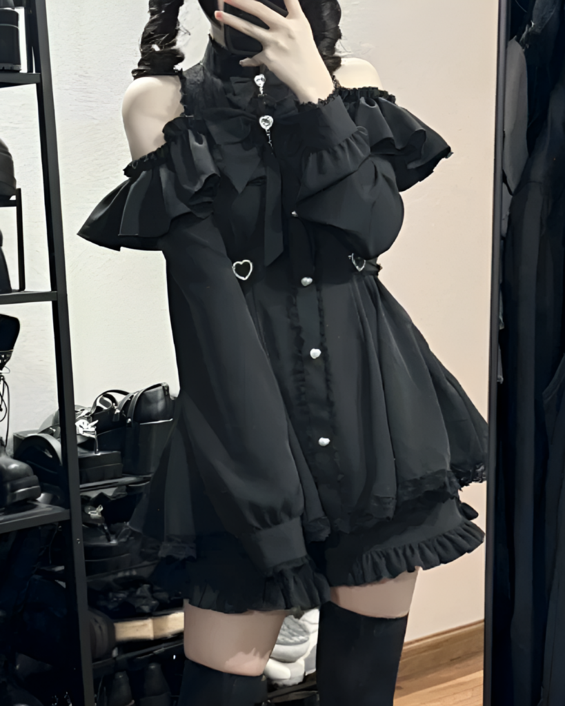 Black Noir Heart Ruffle Cold-Shoulder Coord displayed on a mannequin. Detailed Gothic Lolita coord with ruffles and a heart detail.