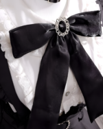 Close-up of the Noir Pearl Pinafore Coord showcasing the Jirai Kei aesthetic and black bow detail.