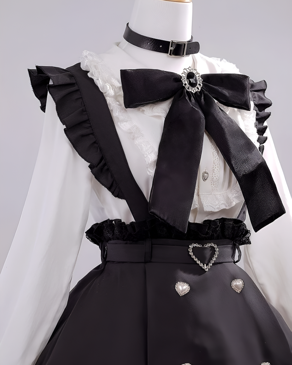 Noir Pearl Pinafore Coord with black suspenders and bow, embodying the Jirai Kei aesthetic. White blouse and black skirt details.