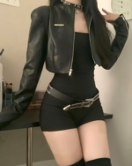 Model wearing a Noir Shadow Crop Moto Jacket, a black E-girl crop jacket with a front zipper. Ideal for a stylish, edgy look.