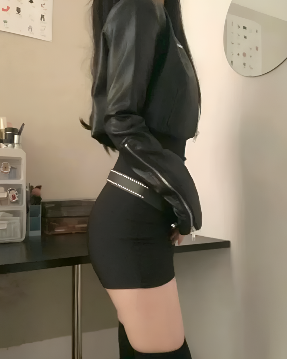 Woman wearing a black Noir Shadow Crop Moto Jacket, an E-girl crop jacket with a cropped fit and zip detailing.