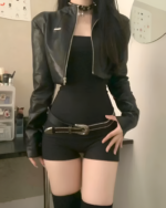 Model wearing a black Noir Shadow Crop Moto Jacket, a stylish e-girl crop jacket paired with a black belt and top.