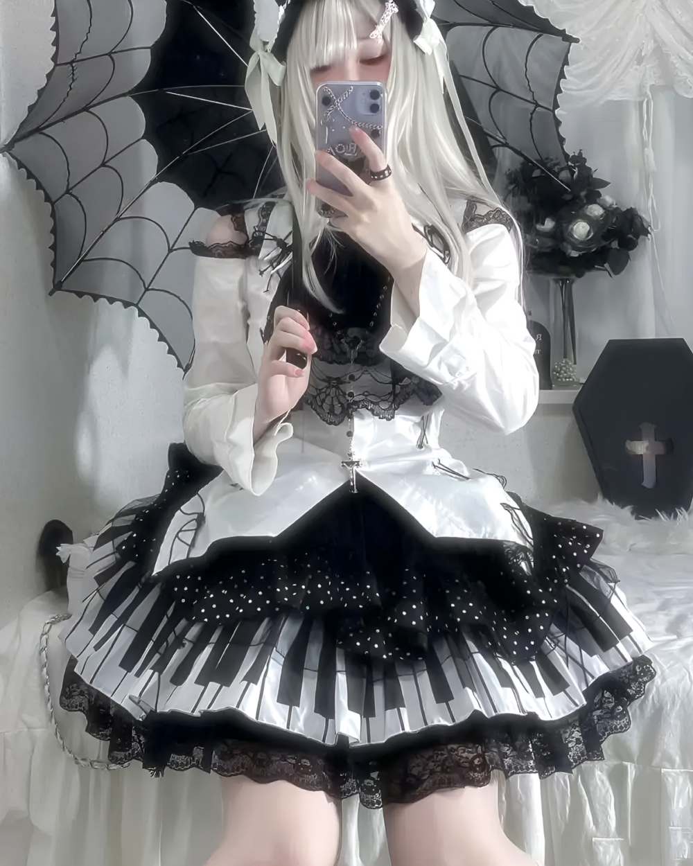 Model wearing the Noir Sonata Skirt, a black and white piano key skirt, with a white blouse and lace details.