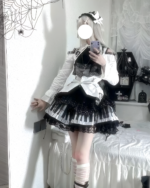 Model showcasing the Noir Sonata Skirt, a black and white piano key skirt, with a Lolita-inspired outfit including knee-high socks.