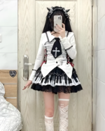 Woman wearing a black and white piano key skirt with a matching top and knee-high socks. Featuring the Noir Sonata skirt.