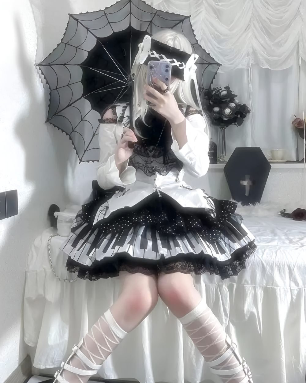 Woman wearing a Noir Sonata Skirt, a black and white piano key skirt, with lace details and a gothic lolita aesthetic.