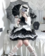 Woman wearing a Noir Sonata Skirt, a black and white piano key skirt, with lace details and a gothic lolita aesthetic.