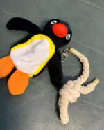 Close-up of a Noosed Penguin Keychain with a rope noose and keychain ring. The penguin is black and white with an orange beak.