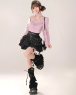 Model wearing a lilac long sleeve shirt and black star chain skirt with platform boots. The skirt features tiered ruffles and star details.