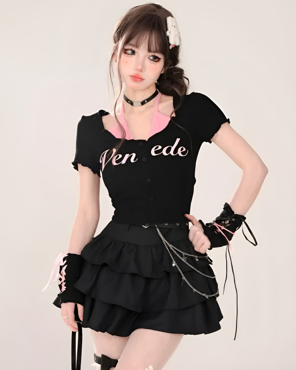 Model wearing a black top and Obsidian star chain skirt. The skirt features a layered design and decorative chains.
