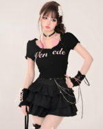 Model wearing a black top and Obsidian star chain skirt. The skirt features a layered design and decorative chains.