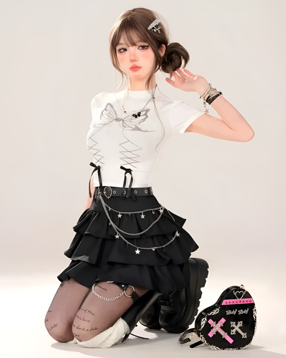 Model wearing a black star chain skirt with a white top and boots. The star chain skirt has a layered, ruffled design.