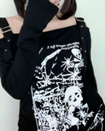 Black Nu-Goth sweater with off-shoulder detailing and graphic print.