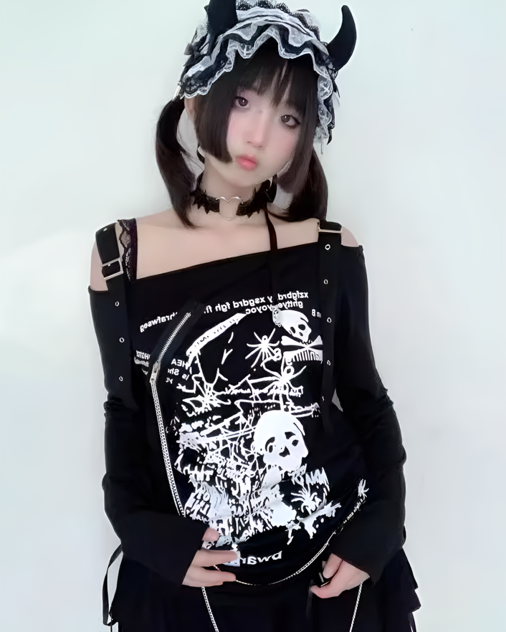 Black and white Nu-Goth sweater with skull print, worn by a model with a black bonnet.