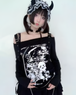 Black and white Nu-Goth sweater with skull print, worn by a model with a black bonnet.