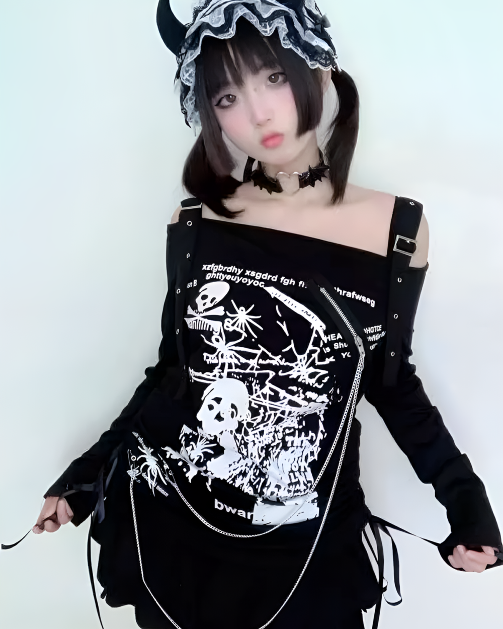 Black Nu-Goth sweater with off-shoulder design and skull print.