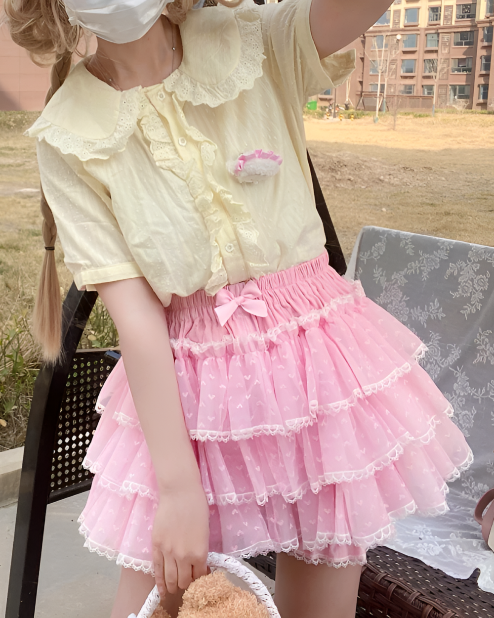 Model wearing Pastel Heart Frill Bloomers with a matching top, showcasing a Yume Kawaii aesthetic. Pink ruffled bloomers with heart details.