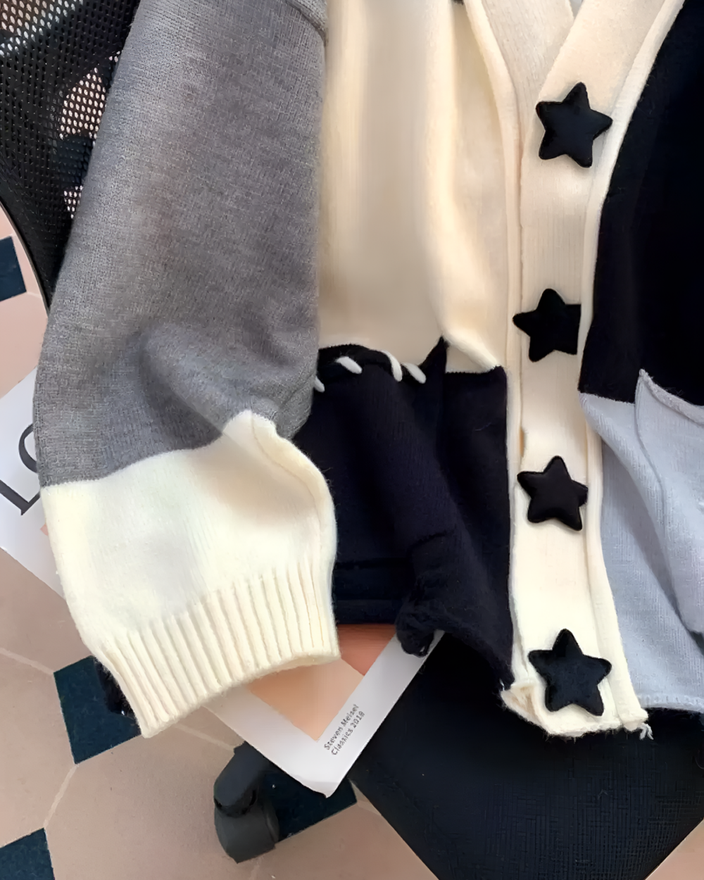 Star print cardigan featuring a patchwork design and star embellishments.