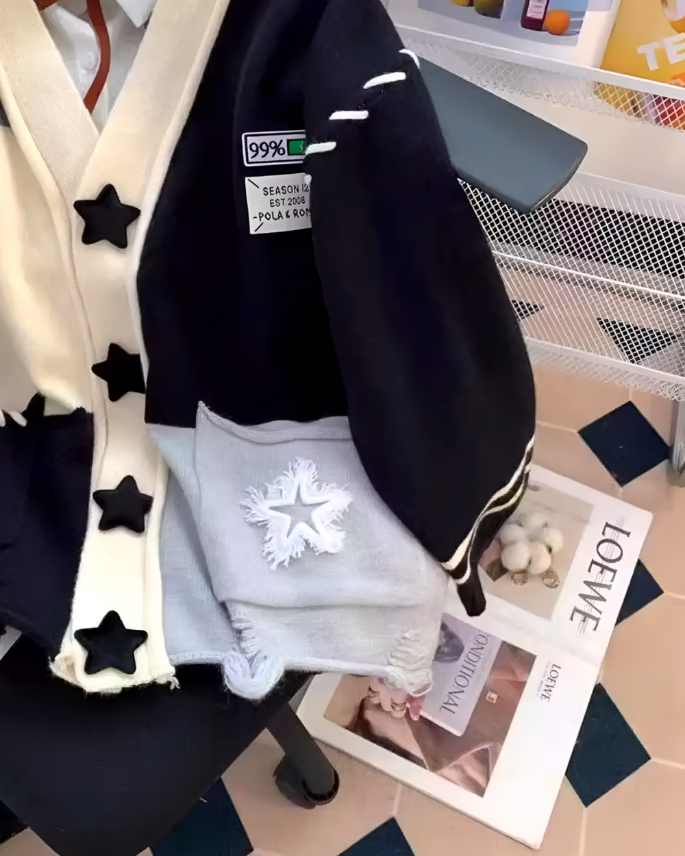 Black star print cardigan featuring a patchwork design and 99% wool. star print cardigan