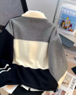 Navy and gray star print cardigan sweater, showcasing a patchwork design.