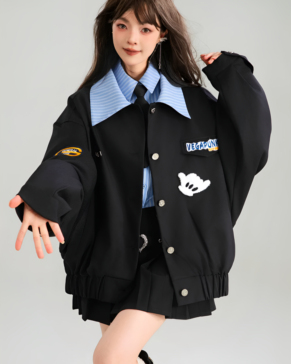 Woman wearing a black Patchy Jacket with colorful patches. Preppy aesthetic outerwear.
