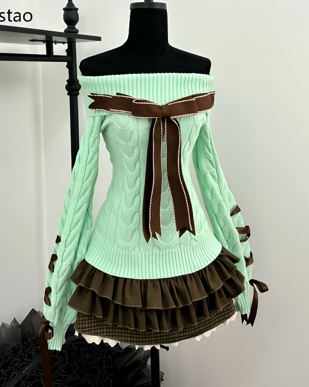 Mint knit set featuring a light green cable-knit sweater with brown accents and a tiered skirt.