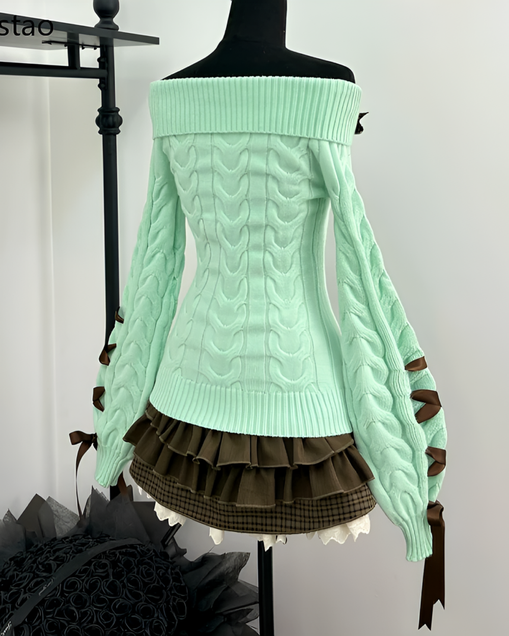 Mint knit set: pale green off-the-shoulder sweater with layered skirt and ribbon accents.