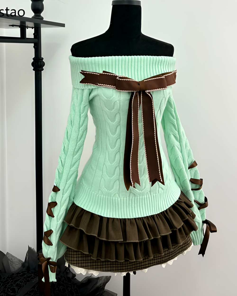 Mint knit set: Light green off-the-shoulder sweater with ruffled skirt and bow details.