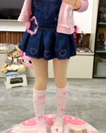 Pink Lolita socks paired with a blue denim skirt and accessories.