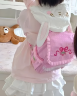 Pink strawberry backpack, Jojifuku Aesthetic style worn by a person.