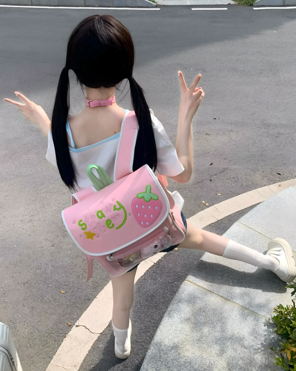Pink strawberry ita bag worn by a girl, Jojifuku aesthetic.