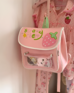 Pink strawberry ita bag featuring strawberry motifs and plush toys.