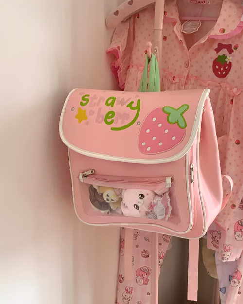 Pink strawberry ita bag featuring strawberry motifs and plush toys.
