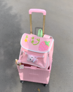 Pink strawberry ita-bag with a trolley, Jojifuku aesthetic, featuring strawberry and strawbery design.
