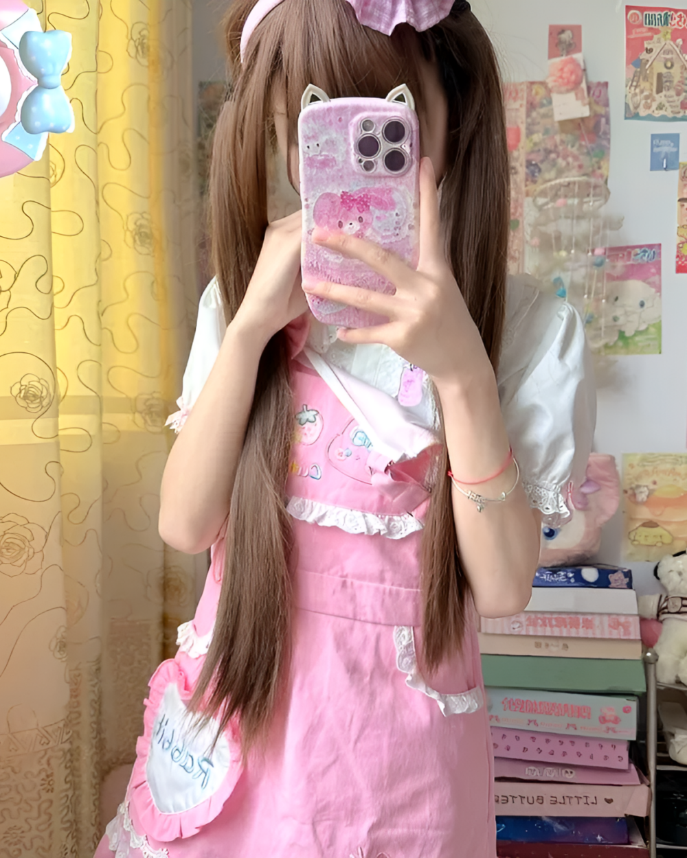 Woman wearing a pink strawberry mini dress by Jojifuku. The aesthetic dress features ruffle details.