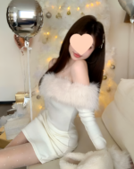 Woman wearing a white Plush Christmas Dress with faux fur sleeves, festive background.