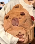 Close-up of a brown Capybara plushie bag with a sewn-on heart design.