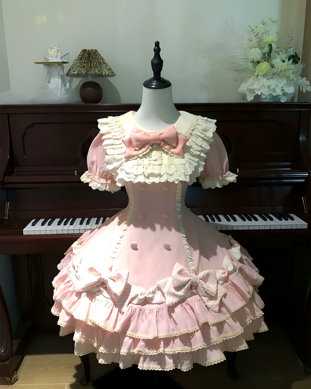 Polka dotted ruffled Hime Lolita dress on a mannequin, featuring a pink and white color scheme.