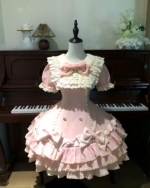 Polka dotted ruffled Hime Lolita dress on a mannequin, featuring a pink and white color scheme.