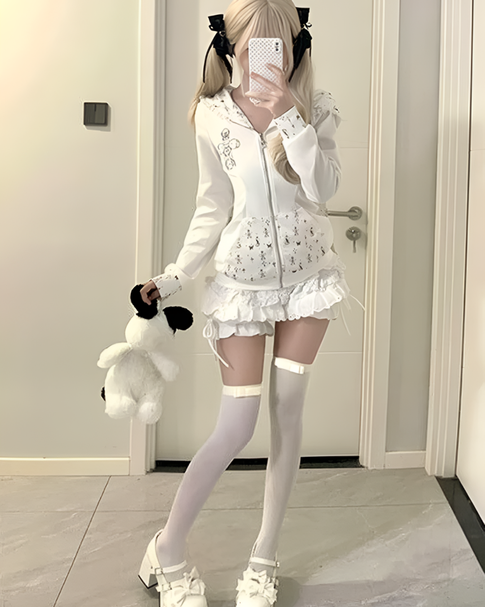 Woman modeling a white floral rabbit eared hoodie with matching accessories. A cute and stylish rabbit eared hoodie outfit.